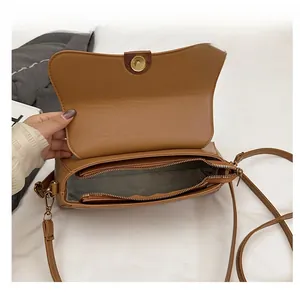 Interior view showing multiple compartments and gold hardware in brown baguette bag