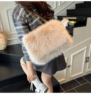 Detail of soft beige faux fur crossbody bag with elegant gold metal chain strap for women