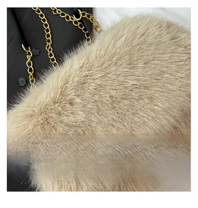 Detail of plush beige faux fur tote featuring premium gold metal chain and leather strap