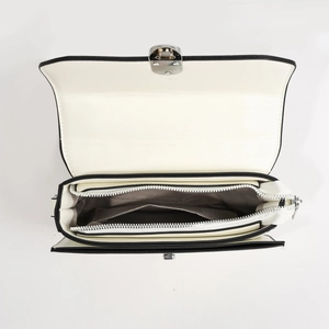 Moderne schwarz-weiße kleine Umhängetasche mit Metalldrehverschluss und mehrlagigem Innenraum