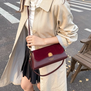 French retro burgundy crossbody bag in mixed leather with gold buckle on trench coat