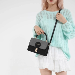 Fashionable black leather and grey woven crossbody bag with metallic lock shown on model