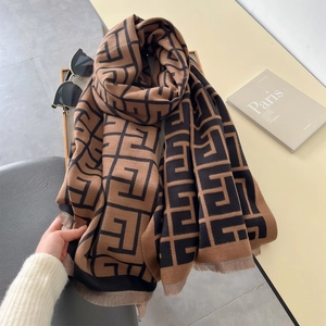 Luxurious brown and black geometric patterned cashmere scarf with stylish fringe details