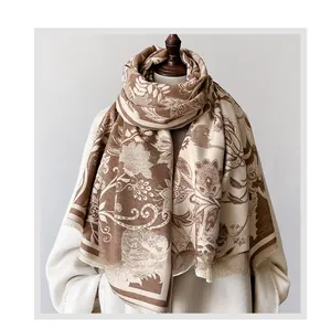 Close-up of vintage floral print shawl with soft fringe detail on brown and beige fabric