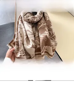 Detailed view of the fine edge lock stitching and floral pattern on this warm shawl