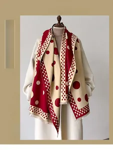 Close-up of thick polka dot scarf with tassels and soft double-sided red and white pattern