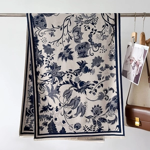 Detail of vintage floral pattern shawl with soft fringe on an elegant white background