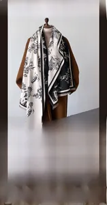 Detail of winter scarf showing retro toile de jouy print and soft cashmere-like texture