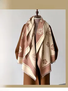Detailed view of floral faux cashmere scarf with fringe and rose pattern on wool coat