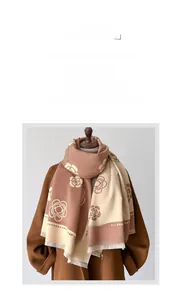 Close-up of brown and beige cashmere-style scarf with elegant camellia patterns