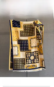 Detail of color-block paisley jacquard scarf featuring fringe edges and ethnic patterns