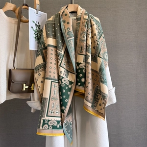 Detail of vintage paisley pashmina shawl with tassel trim draped over a coat