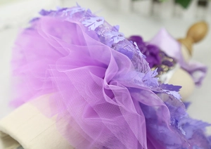 Detail of multi-layered purple tulle dog wedding dress with sparkling leaf appliques