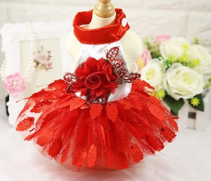 Detail of red pet wedding dress with 3D floral embroidery and sparkly sequined mesh layers