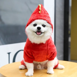Detail of red dinosaur dog onesie with soft fleece texture and spinal plates