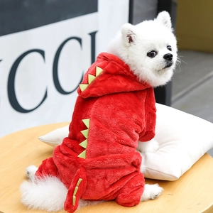 Detail of red dinosaur dog onesie showing green felt scales and warm fleece texture