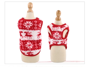 Detail of red and white Christmas pet sweaters with reindeer patterns and fleece fabric
