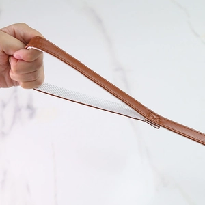 Detail showing the brown leather pet leash with reinforced white webbing and strong stitching