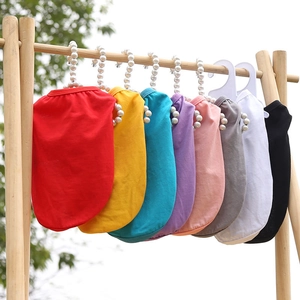 Colorful knitted pet vests for dogs and cats displayed on elegant pearl hangers