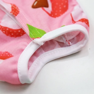 Macro detail of pink strawberry print pet recovery suit with reinforced white edge stitching