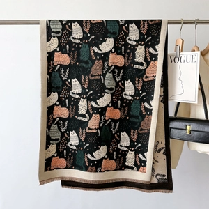 Detail of double-sided cat print scarf with fine fringe edges and knit texture