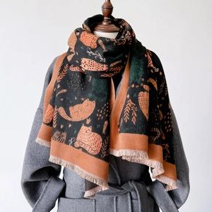 Cat pattern double-sided cashmere-like knit shawl with tassels on a grey coat