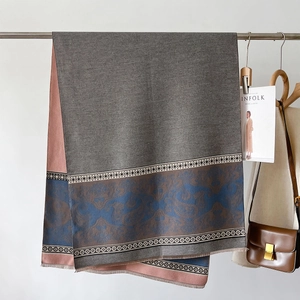 Detail of cashmere-like shawl featuring blue baroque jacquard pattern and fringe edges