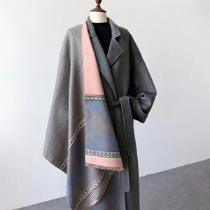 Detail of gray cashmere-style coat paired with a pink and blue patterned shawl