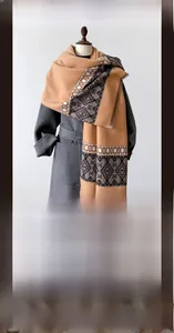 Close-up of thick cashmere-like scarf with camel and brown geometric ethnic patterns