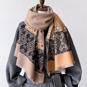 Elegant geometric rhombus shawl with fringe detail layered over a classic wool coat