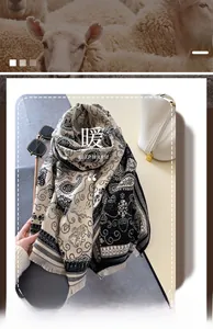 Detailaufnahme des dicken schwarz-weißen Paisley-Strickschals mit Fransenstruktur