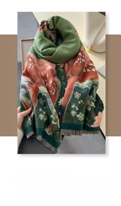 Detailed view of floral and animal prints on a thick faux cashmere scarf with fringe