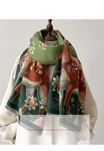 Detail of floral and deer pattern on thick double-sided cashmere-like winter scarf