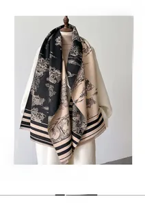 Detail of faux cashmere scarf featuring landscape print and black tassel fringe edges