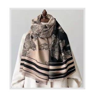 Detail of vintage forest landscape print on a beige and black oversized scarf