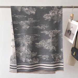 Detail of landscape print scarf with fringe edges and soft drapes for winter fashion