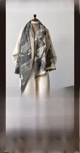Detail of soft gray butterfly pashmina scarf styled on a winter coat for women