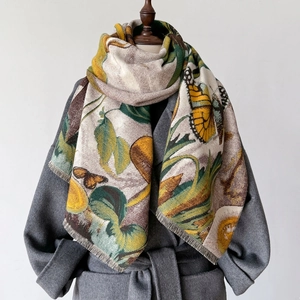 Thick butterfly print cashmere-feel shawl with tassels over a grey coat