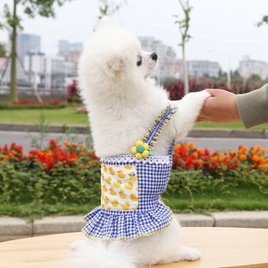 Detail of blue plaid pet dress with lace trim and cute yellow duck pocket for dogs