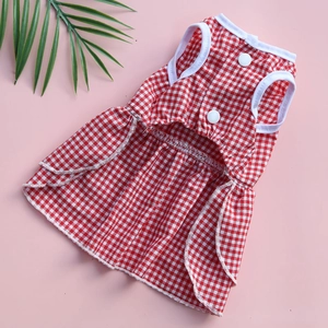 Detail view of red gingham dog dress with white buttons and ruffle hem for small pets