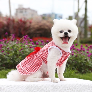 Detail of red plaid pet dress featuring a large bow on the back for small dogs