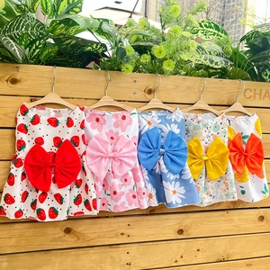 Selection of plaid pet dresses with oversized bows in five vibrant floral patterns