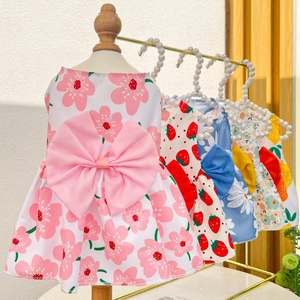 Detail of assorted plaid pet dresses featuring large bows in pink, blue, and yellow hues