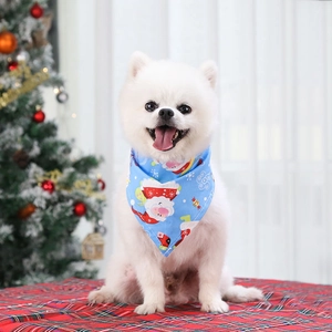 Detailed close-up of blue Christmas pet bandana with festive Santa and snowflake patterns