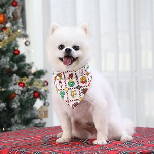 Close-up of white pet bandana with gingerbread and Christmas motifs on a Pomeranian dog