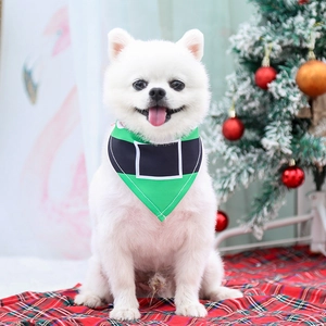 Detail of green Christmas elf pattern pet bandana with belt buckle design on soft fabric