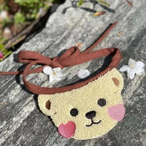 Cute brown bear pet bandana scarf in yellow fleece for small dogs and cats on rock