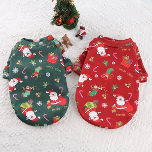 Close-up of red and green pet Christmas sweatshirts with Santa and snowflake prints