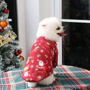Close-up of red fleece Christmas pet sweater with Santa print on a small dog