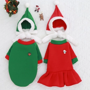 Flat lay of festive red and green Christmas pet sweater sets with matching reindeer hats